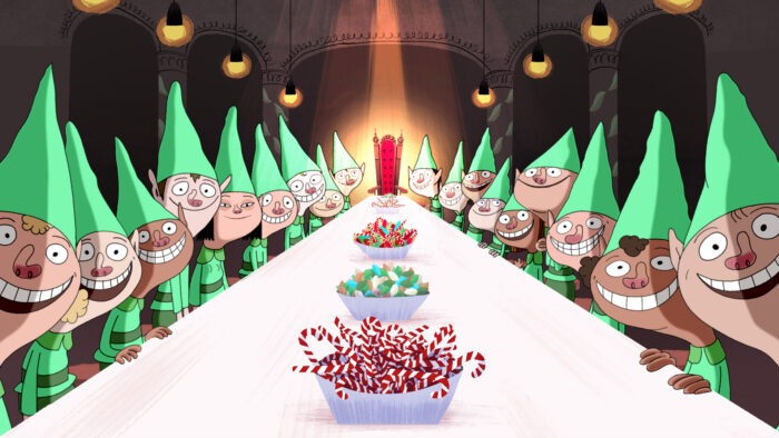 Image du film Anta Claus - 18 lutins à table. Sur la table, des sucreries et au bout d'une grande table blanche, une longue chaise rouge.